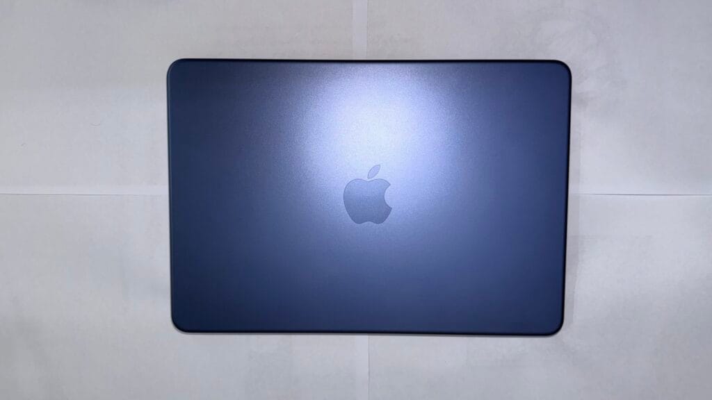 Apple MacBook Neo in Indigo color with aluminum lid and centered Apple logo