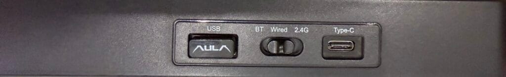 Rear view of my Aula F75 keyboard showing the USB receiver storage, BT/Wired/2.4G mode switch, and USB-C charging port.